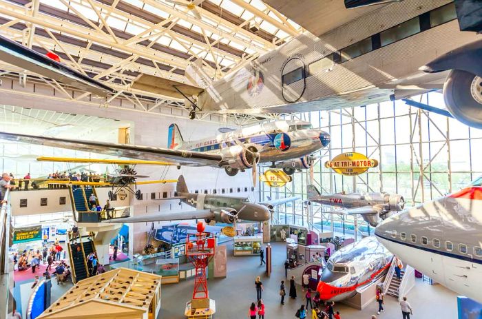 An expansive exhibit featuring planes and various flying machines within a museum setting.