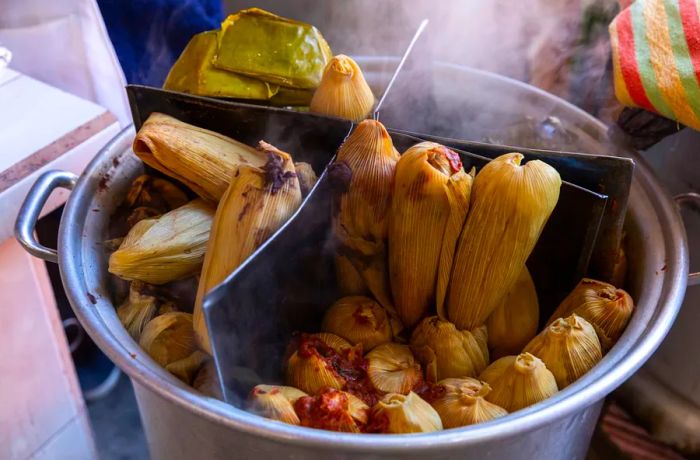 A pot of steaming tamales