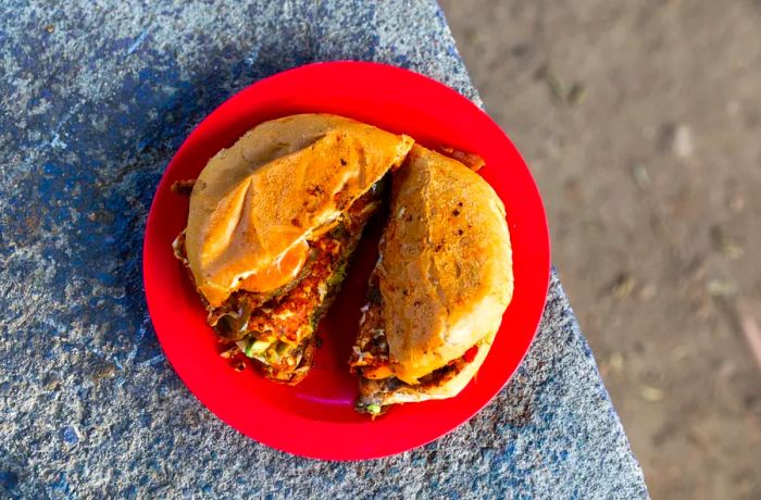 A torta served on a red plate under the sun