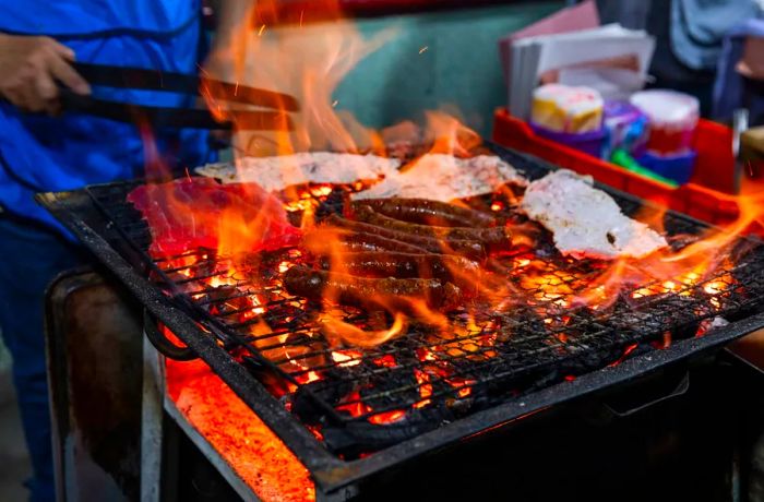 Meat sizzling amid flames on a grill