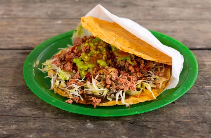 Ground meat nestled between two crispy tostadas.