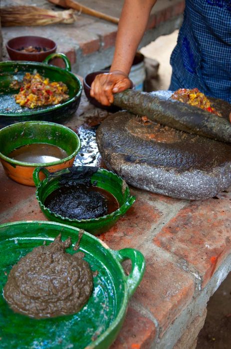 Ingredients are crushed on the stone metate.