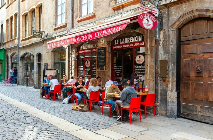 Outdoor terrace of a restaurant in historic Lyon during summer