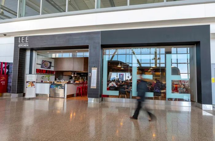 A passenger strolls past an airport restaurant