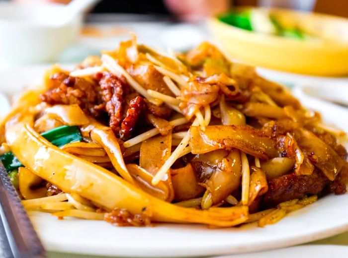 A noodle dish adorned with a variety of seafood.