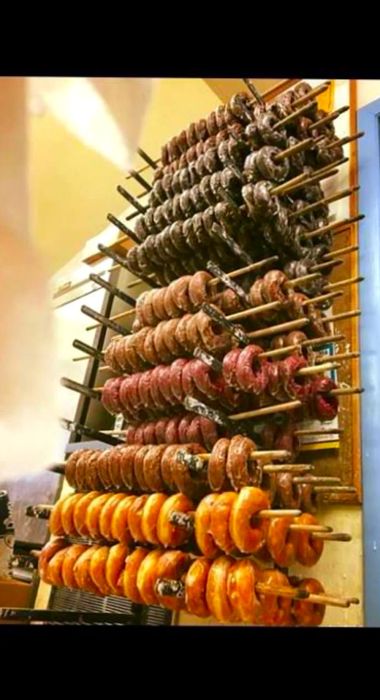 Doughnuts displayed on wooden racks