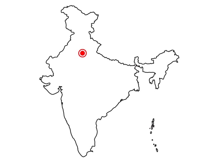 A map of India highlighting New Delhi with a red dot.