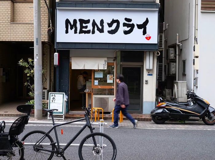 The restaurant’s facade features bold signage in both Japanese and English.