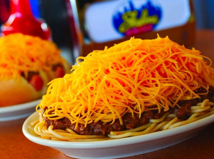 A close-up of a three-way dish with two coneys in the background.