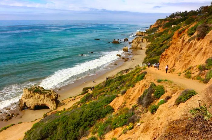 Visitors walking the path to El Matador State Beach in Malibu