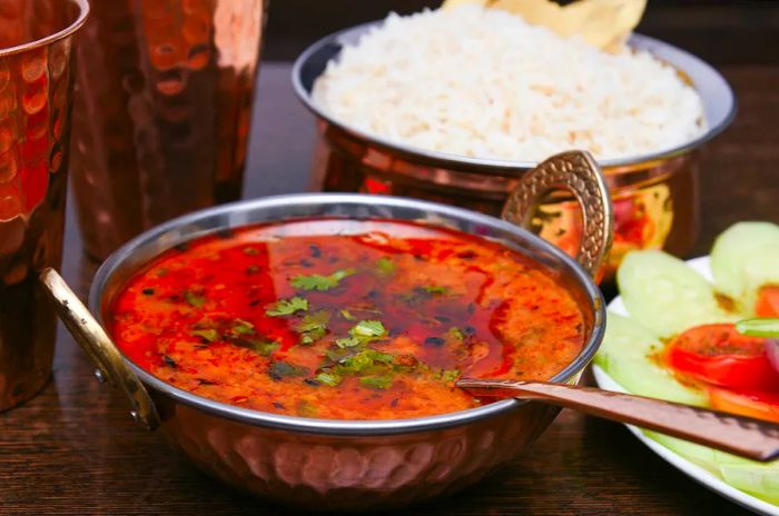 A copper bowl filled with dhal fry in Rajasthan, India.