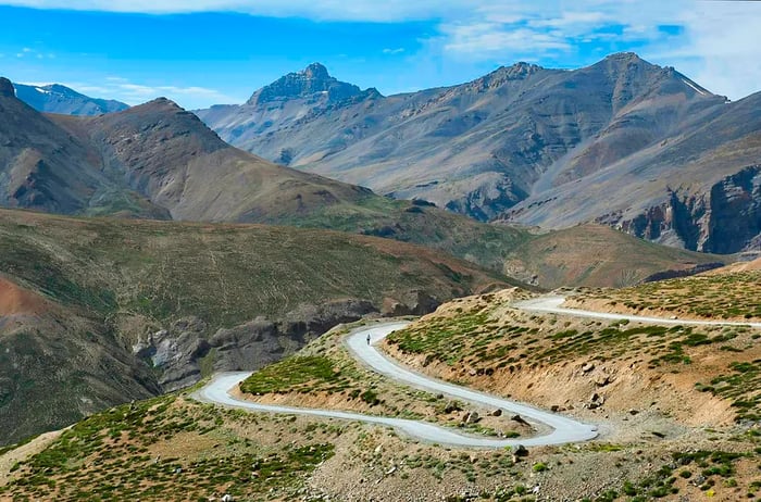 A cyclist navigates a switchback road in the mountains of Ladakh, India