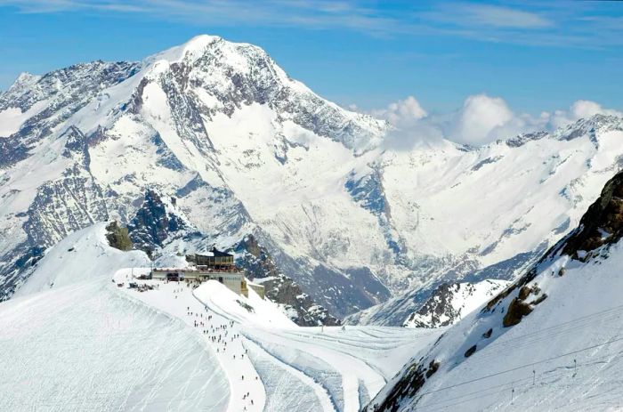 Allalin lift station and revolving restaurant in Saas Fee. This circular structure sits atop a mountain, offering panoramic views of the Swiss Alps.