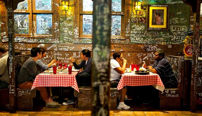 Patrons enjoy their meals in the dining area of Gino's East restaurant in Chicago, Illinois.