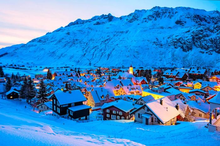 The village of Andermatt in the Swiss Alps, blanketed in snow.