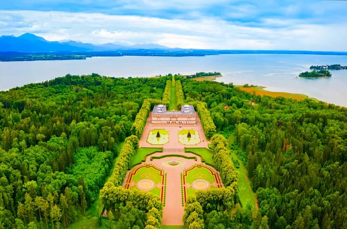 An aerial perspective of Herrenchiemsee Palace, a complex of royal structures situated on Herreninsel, the largest island in Chiemsee lake, in southern Bavaria, Germany.