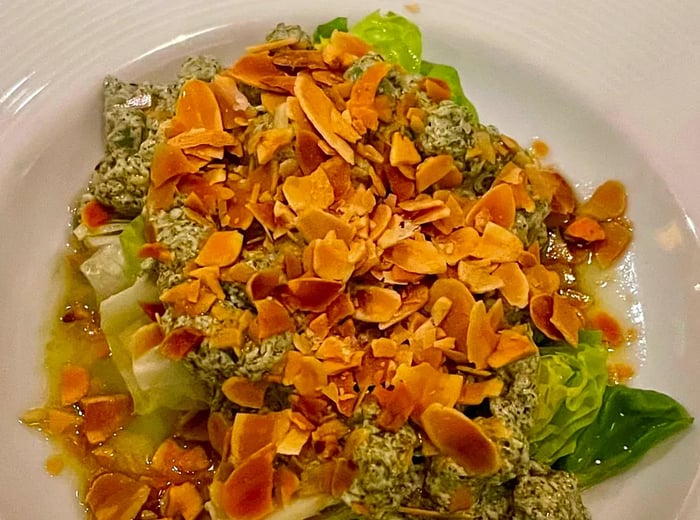 A vibrant arrangement of greens garnished with sliced almonds.