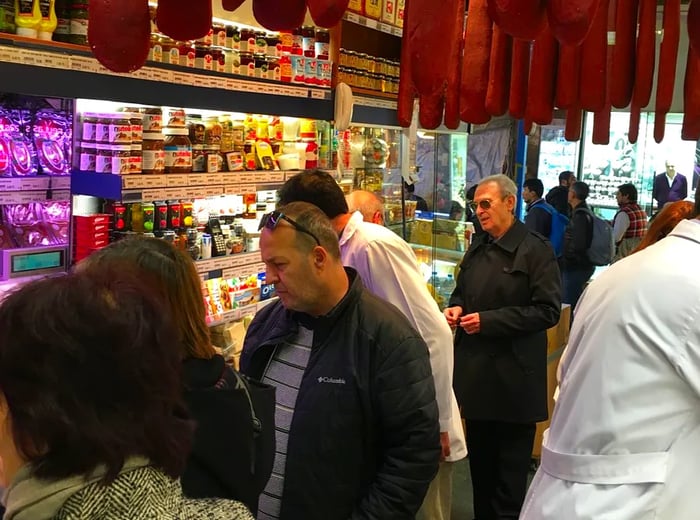 A bustling market scene filled with shoppers.