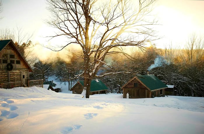 A winter wonderland featuring cozy cabins.