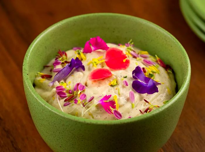 A custard bowl beautifully adorned with an array of edible flowers.