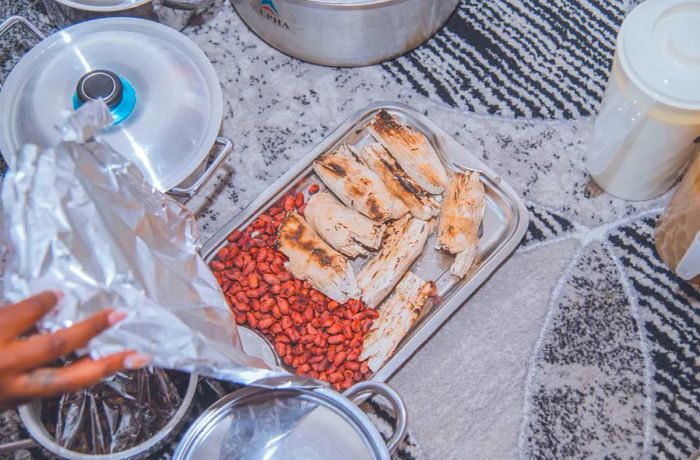 A tray filled with roasted groundnuts and pieces of cassava.