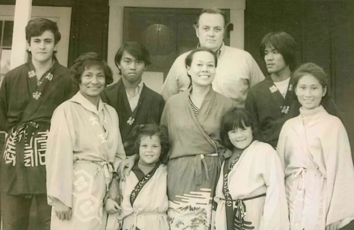 A vintage black and white snapshot of a family.