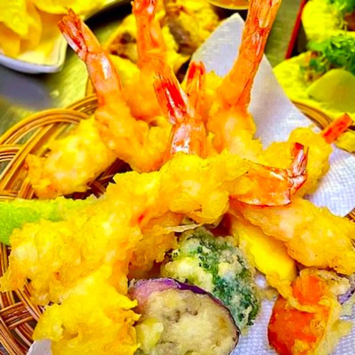 Golden tempura nestled in a wooden basket.