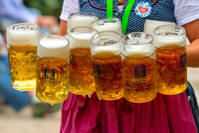 A waitress balances nine beer servings as she navigates the tables at the Dachau Volksfest in Bavaria, Germany.