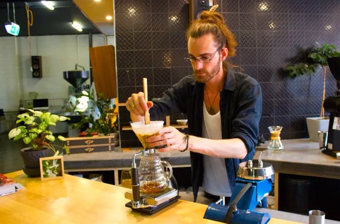 A barista crafts a drink at Aunty Peg’s.