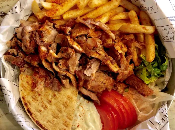 A spread of pita, vegetables, and succulent meat from Kalimera Souvlaki Art