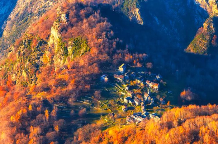 Aerial view of the mountain village of San Giorgio in northern Italy, glowing with autumn colors.