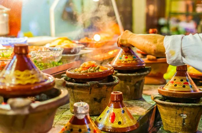 A vibrant array of Moroccan tajines (traditional casserole dishes) showcased in a restaurant setting