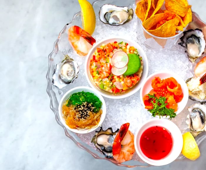 Aerial view of a seafood platter showcasing various vibrant fish and seafood dishes atop a bed of ice.