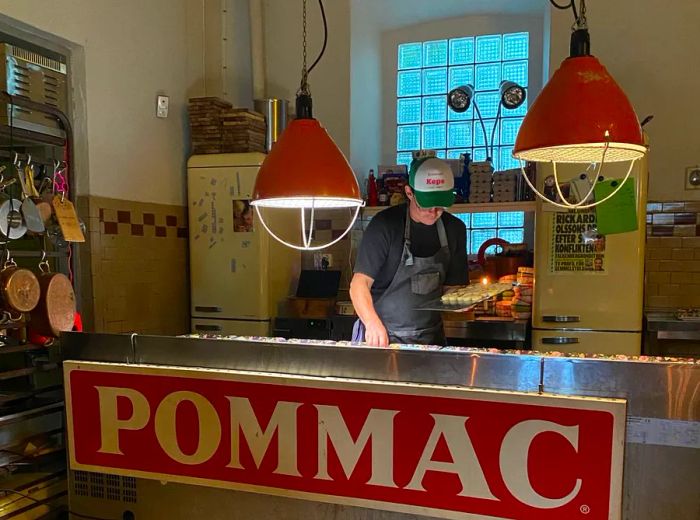 A chef is busy working in an open kitchen.