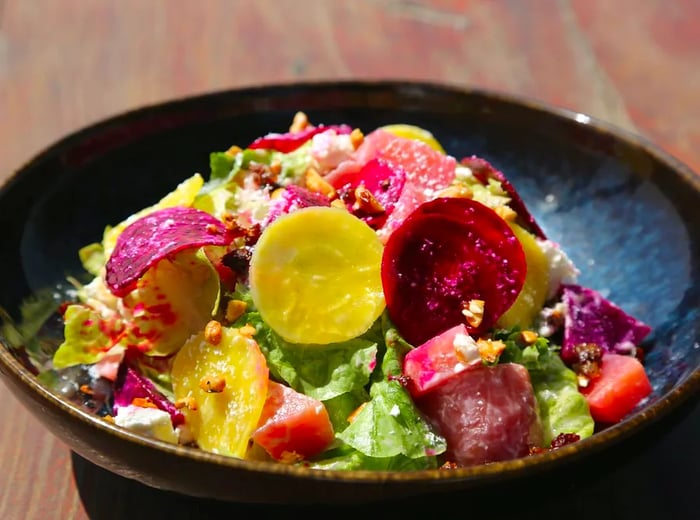 A close-up of a vibrant salad featuring sliced beets.