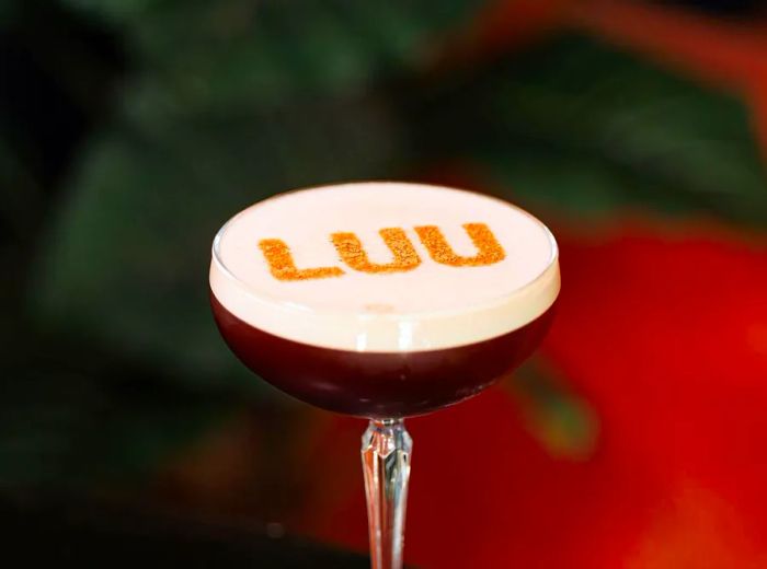 A cocktail featuring the name Luu elegantly stenciled on the foam.