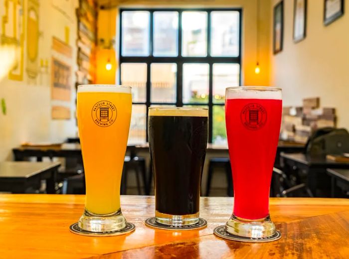 Three pints of beer showcasing a range of colors.