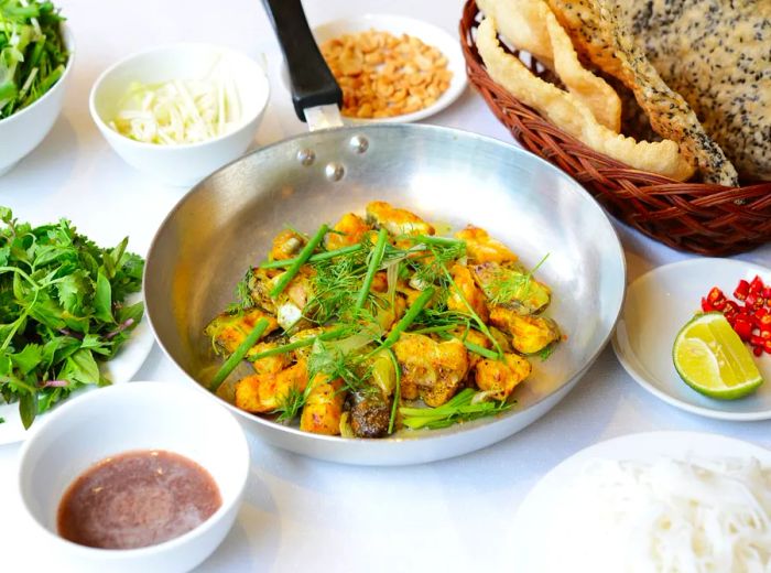 A skillet brimming with fish and herbs, accompanied by additional condiments and bread.