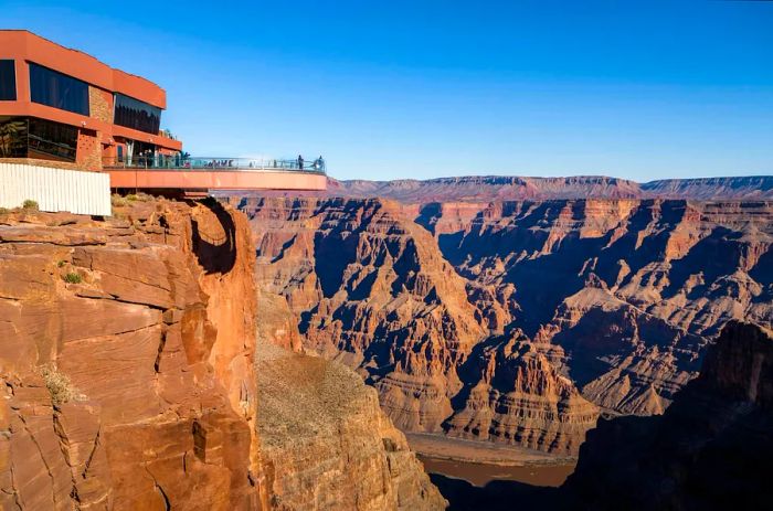 Visitors stroll across the Skywalk bridge at the Grand Canyon's West Rim in Arizona