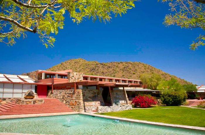 A dusty pink stone house known as Taliesin West, designed by Frank Lloyd Wright in Scottsdale, Arizona