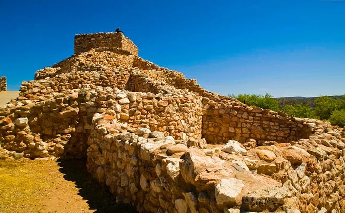 The sunlit stone foundations of the pueblo at Tuzigoot National Monument in Arizona.