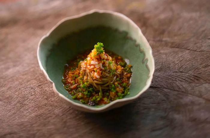 A mound of noodles served in a shell-like dish.