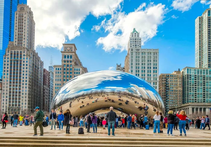 Visitors enjoy the iconic Cloud Gate at Millennium Park during early spring.