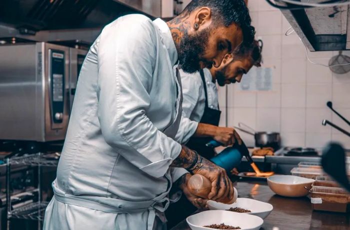 Two chefs working diligently in the kitchen.