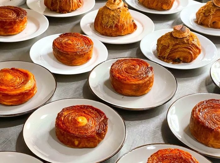 A variety of layered pastries, elegantly displayed on individual plates.