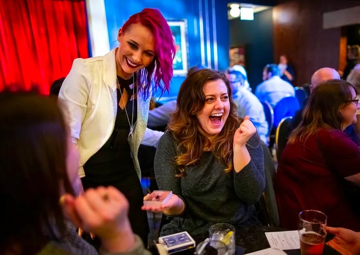 Magician Paige Thompson dazzles guests with her tricks at Chicago Magic Lounge, entertaining them at their tables.