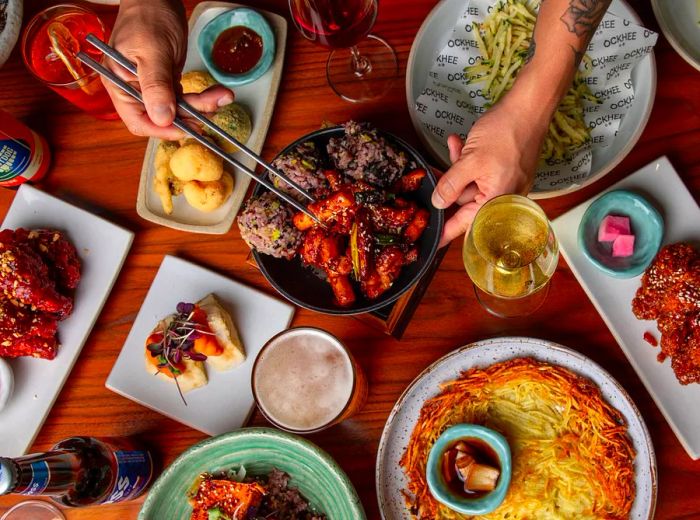 From an overhead view, guests enjoy a diverse array of Korean dishes.