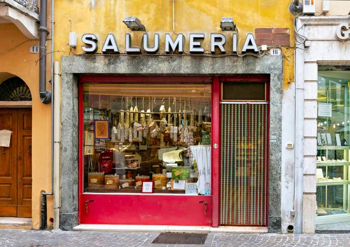 The storefront of a traditional salumeria (delicatessen) in central Mantua (Mantova), Italy.