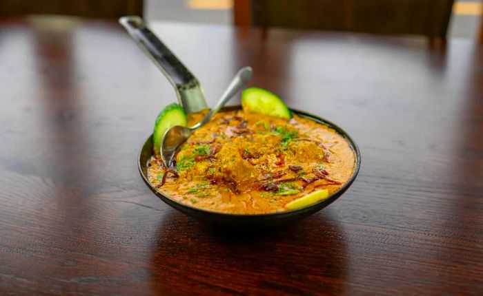 A skillet filled with a vibrant orange stew.