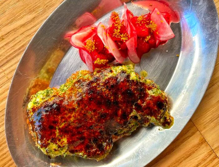 From an aerial view, duck schnitzel paired with an elaborate vegetable side dish.